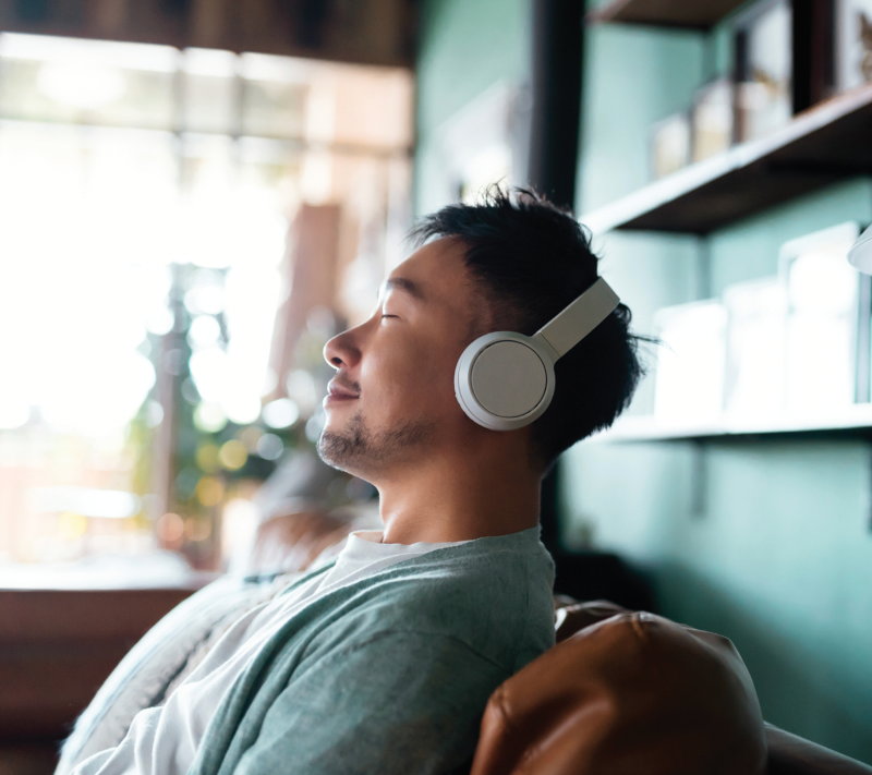 A man relaxing while wearing headphones